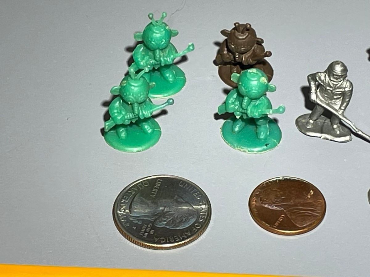 Vintage 60s plastic alien and astronaut figures in various poses 