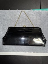 VINTAGE black patent leather clutch bag with a gold-tone chain strap.