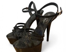 Black platform heels with gold accents, featuring a 4 inch heel 2 inch platform.