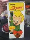 1986 Porcelain Drink Squirt sign by Ande Rooney.Measures 14”x 6”. Vintage