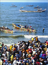 2006 Print Fishermen Race in Boats to Pull in Fish at MBour Senegal Africa