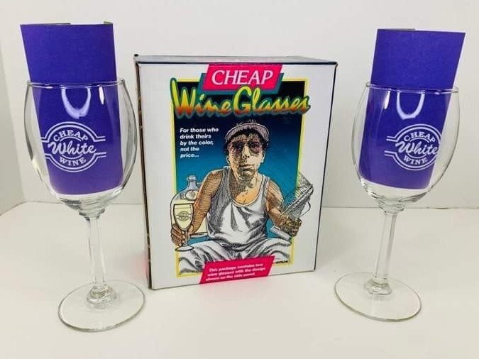 Spencer Gifts 'Cheap White Wine' novelty glasses still in original box — a delightfully self-aware vintage barware set ready to gift straight out of the time capsule.