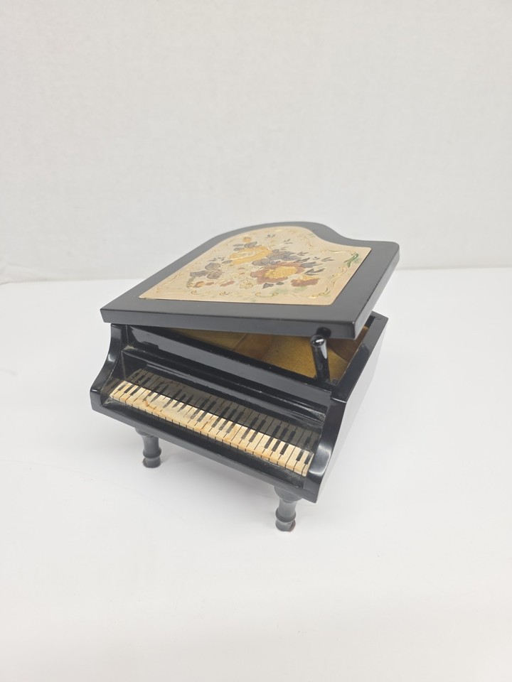 A miniature black lacquer grand piano music box made in Japan — tiny, perfectly crafted, and doubles as a trinket box for rings or earrings.