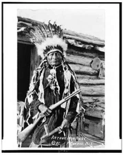 Arthur Iron Nest,rifles,calumets,Indians,peace pipe,cabin,dress,F Cundill,c1912