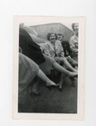 Women showing legs sitting on car -    Vintage snapshot photograph playful