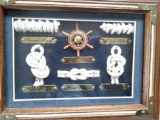 Wooden box with hinged lid decorated with nautical knots and ship's wheel