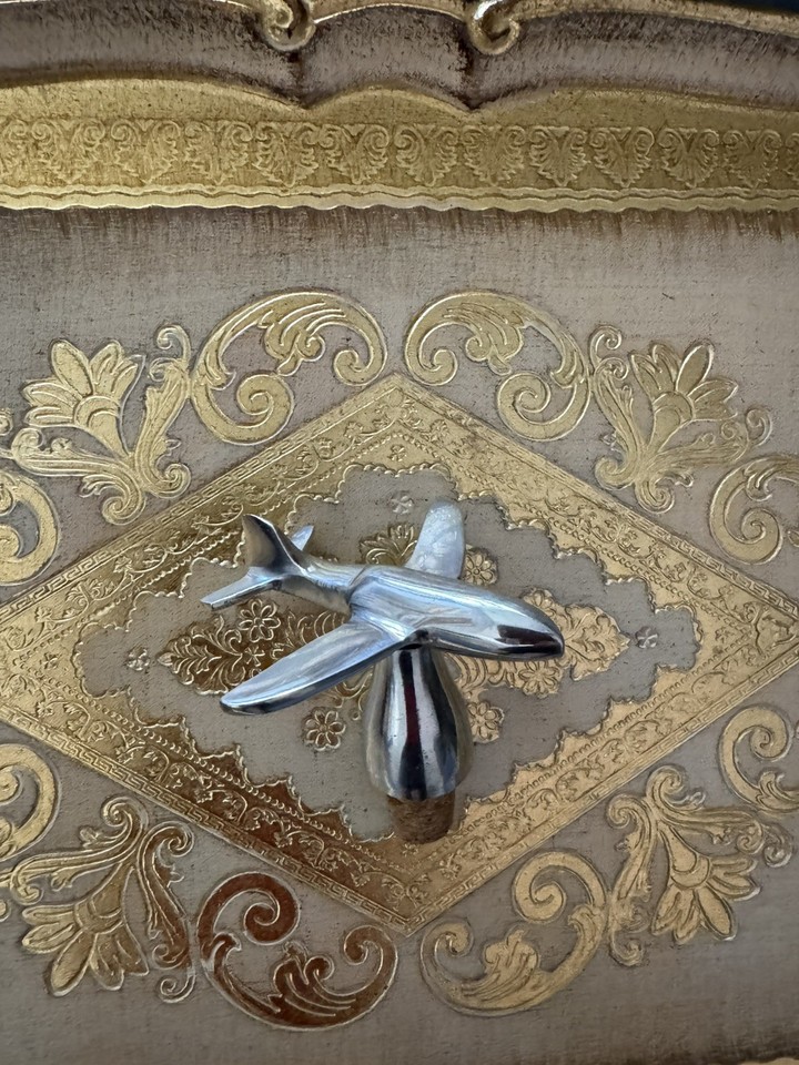 A chrome airplane bottle stopper that doubles as a tiny sculpture — the perfect gift for a pilot, aviation buff, or anyone with a quirky bar.