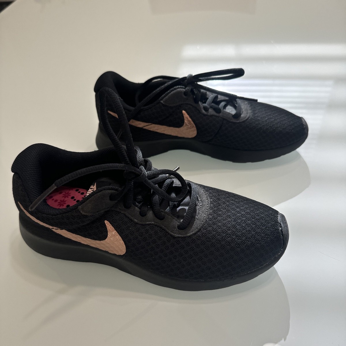 nike tanjun black and gold womens