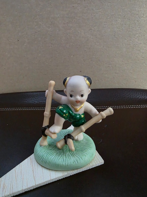 Thailand Crafted Porcelain Fig.- "Boy on Bamboo Stilts" by SIRIN, (HUMMEL-Like)