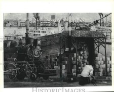 1990 Press Photo Daniel Robertson maintains Rivertown's river front mural