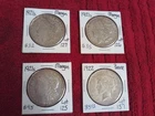 3 Morgan 1921S (Fine-X Fine) and one 1922 Peace (VG) FOUR SILVER DOLLARS One Bid