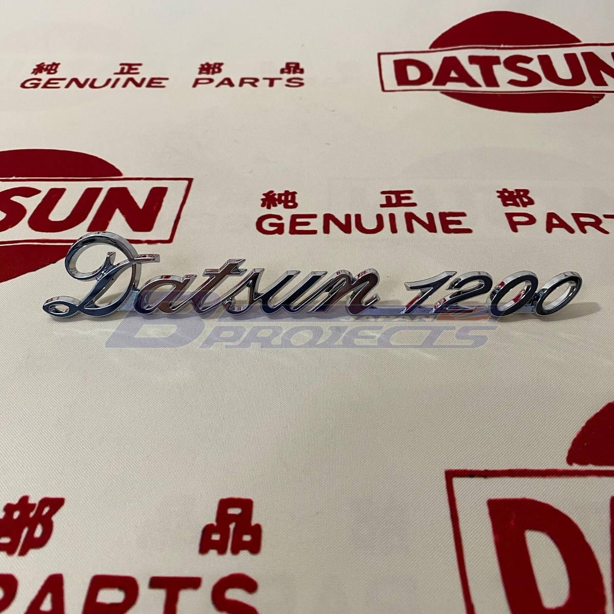 DATSUN 1200 Trunk Lid Emblem Boot Badge Genuine (Fits NISSAN B110 