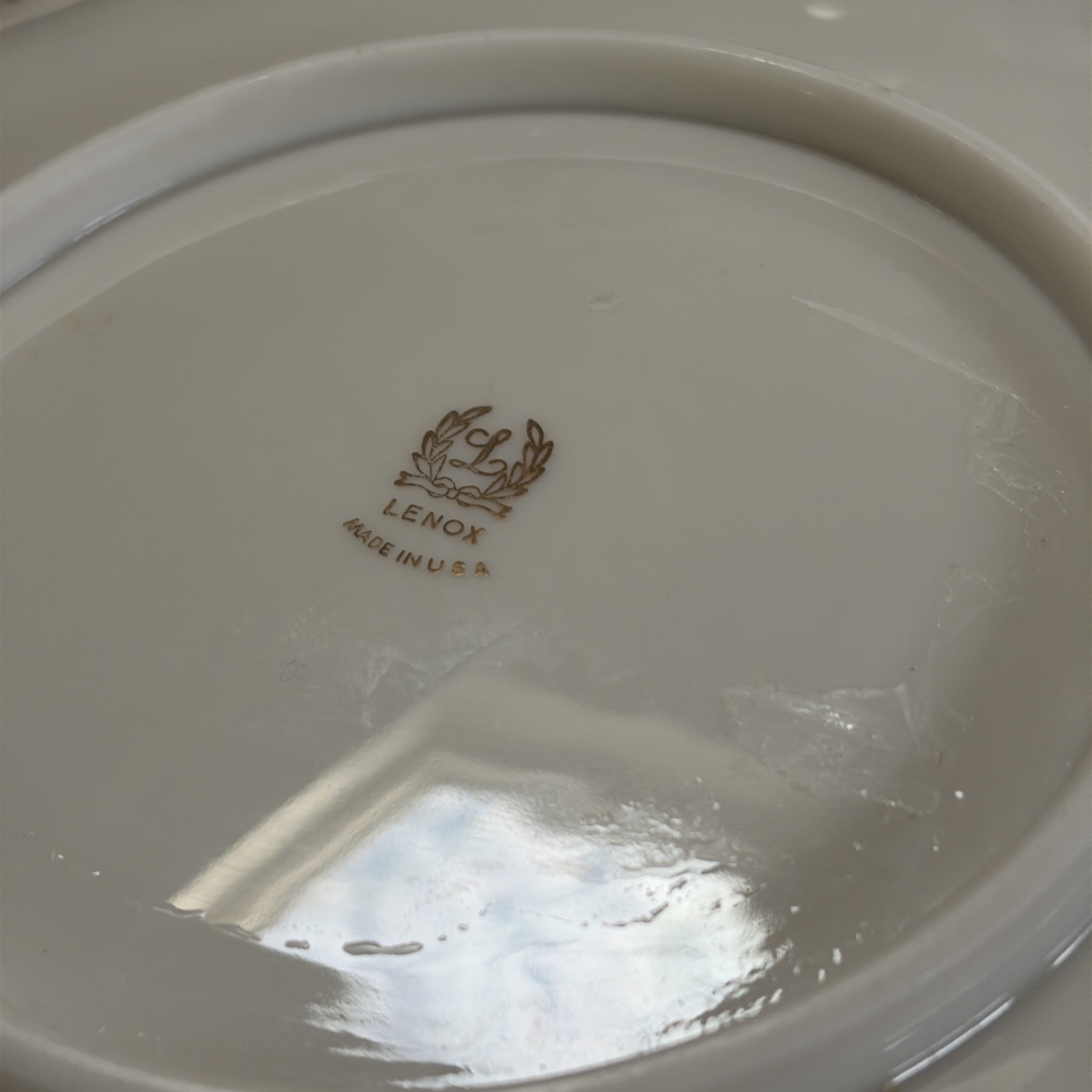 White porcelain Lenox Vintage Pheasant bird Ashtray with gold rim, made in U.S.A. on reflective surface.