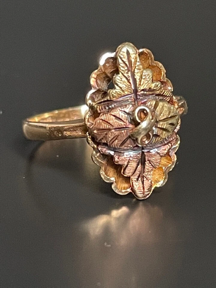 Premium Photo | Gold ring with a small diamond. frame in the shape of grape  leaves based on the black hills