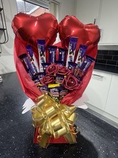 Cadbury Bouquet With Diamanté Centred Red Roses And Two Heart Shaped Balloons
