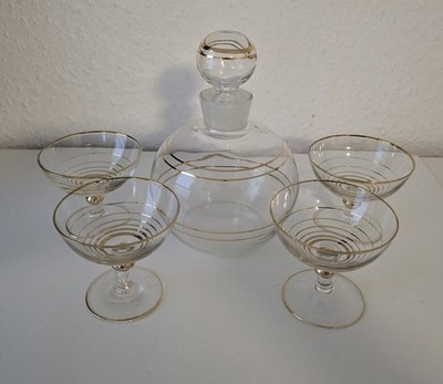 This is a vintage Art Deco decanter and  glass set.