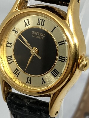 Seiko Quartz Women's Gold Tone Bezel Black Leather Band Watch 1NO1