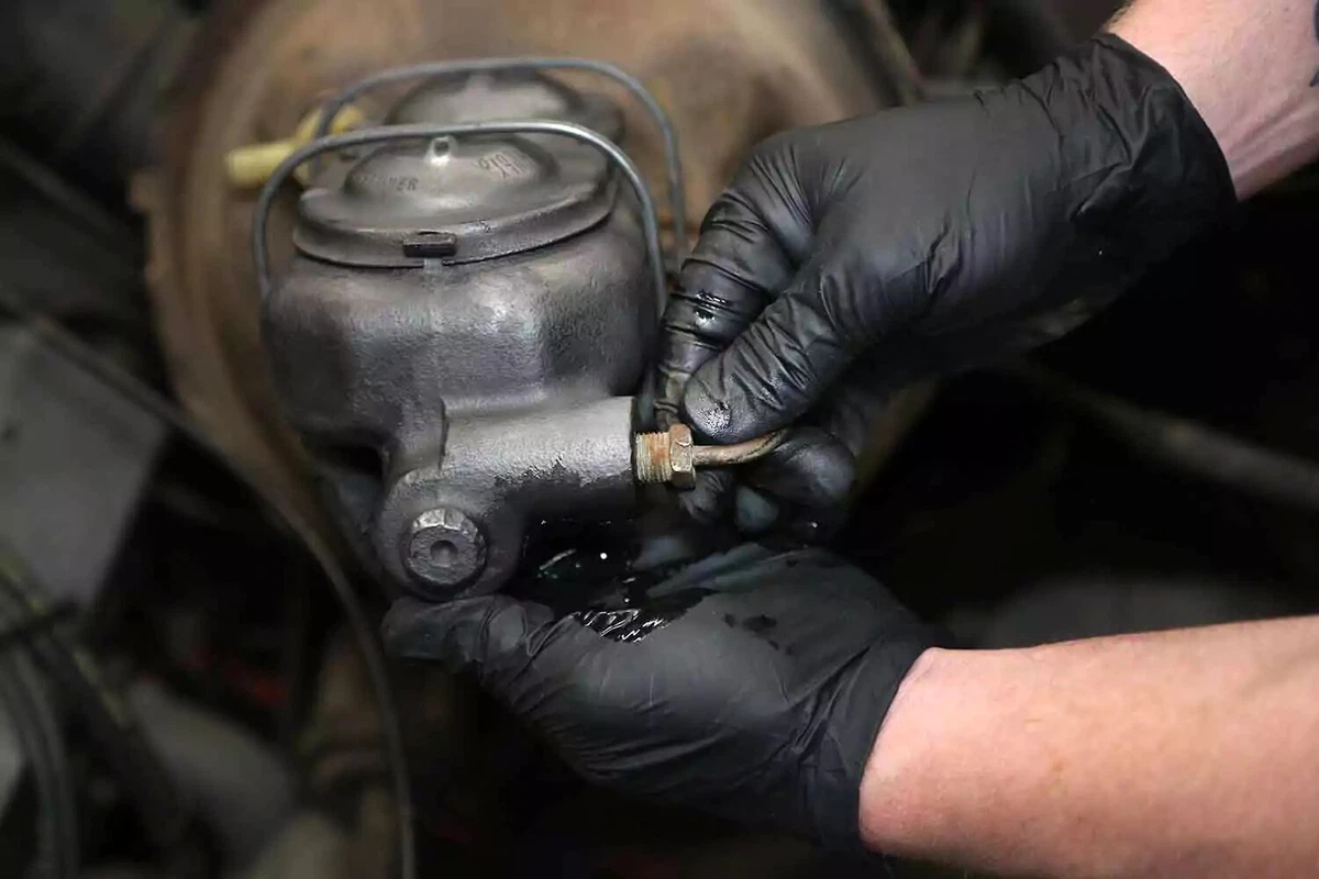 Connecting brake fluid lines.