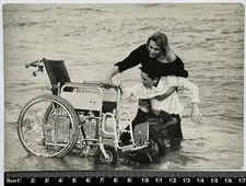 Old photo: A woman next to a girl on his wheelchair by the sea Old Photo