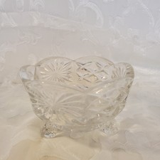 vintage pressed glass candy bowl featuring a scalloped rim  three-footed base