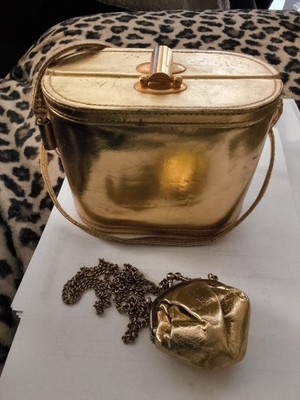 This image shows a gold-colored, oval-shaped object that appears to be a vintage