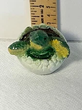 Hatching baby turtle figurine aged wear
