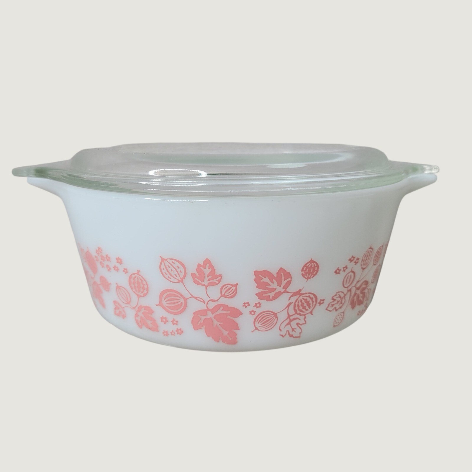 Pink and white Pyrex casserole dish with the Gooseberry pattern and matching lid