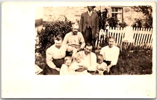 Family of Eight Sit Together on Front Lawn for Portrait - Vintage Postcard