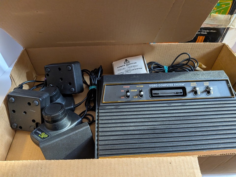 A tested, boxed Atari 2600 with Pac-Man — a genuine piece of gaming history that still works and looks incredible on a shelf.