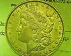 1887 O US MORGAN SILVER DOLLAR IN ABOUT UNCIRCULATED CONDITION