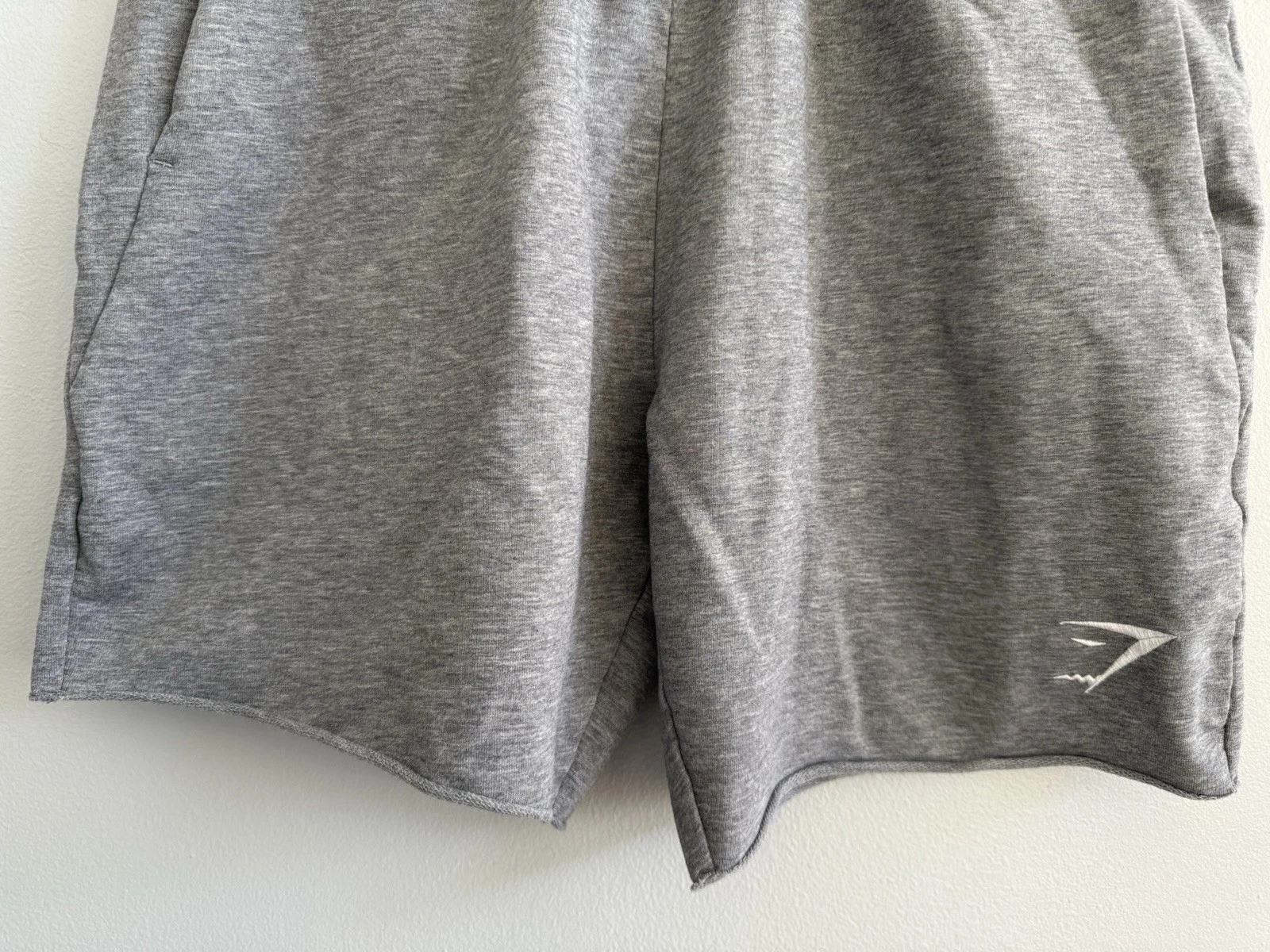 gymshark athletic raw hem elastic waist pockets shorts