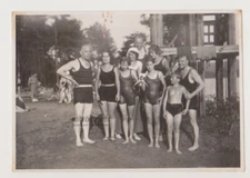 Shirtless Men and Young Women in Swimwear Embrace Happiness on the Beach Photo