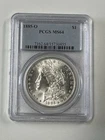 1885-O Morgan Silver Dollar, PCGS MS64. Satiny white luster over mirror surface