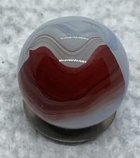 A Vintage Akro Agate Oxblood Patch Marble. Measures .63  Inch. In Mint Condition