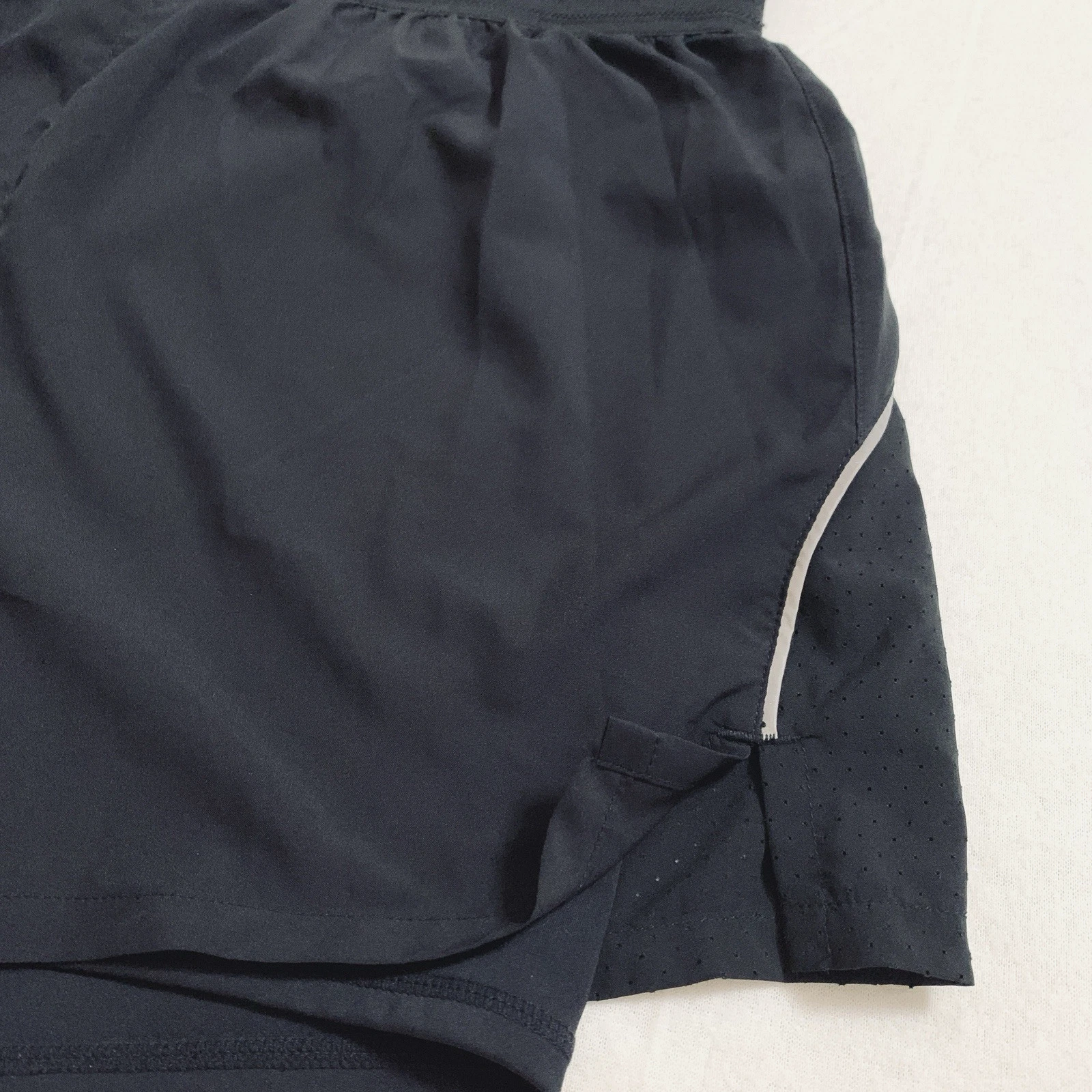 fabletics perforated run inner short with phone pocket shorts