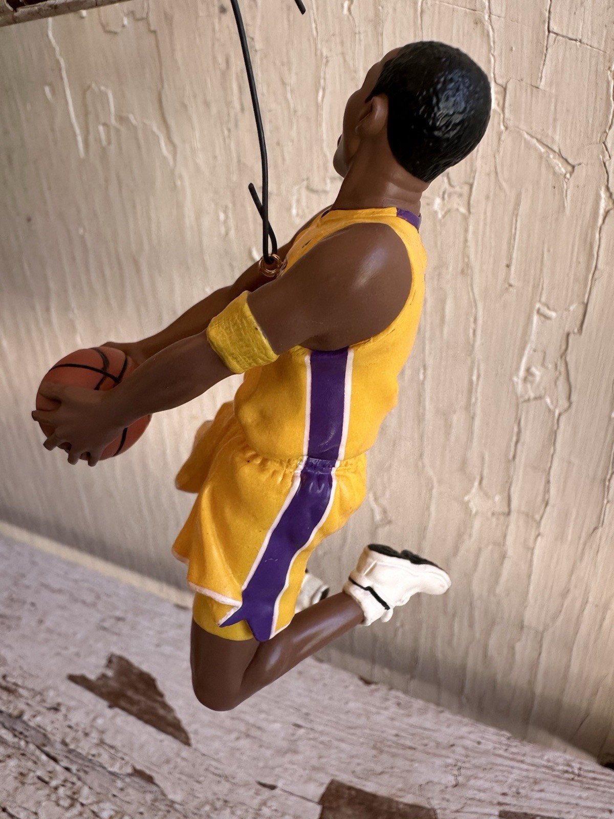 2003 Hallmark Hoop Stars ornament of Kobe Bryant in yellow Lakers uniform holding basketball, purple side stripe.