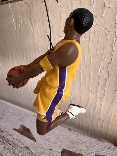 2003 Hallmark Hoop Stars ornament of Kobe Bryant in yellow Lakers uniform holding basketball, purple side stripe.