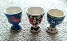 Lot of 3 folk art, painted Egg Cups approx 2 1/2",  2  signed  SEDEF 