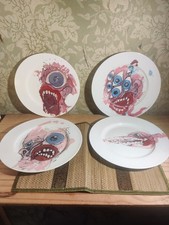 unique, hand-painted decorative plates featuring abstract, monstrous faces