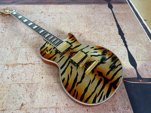 The golden tiger patterned LP electric guitar is on sale at a low price in stock