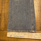 Blue Theory jeans, 30x33, with faded front seam detailing, laid flat on wooden ruler labeled “Speed Queen Equipment.”