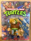 VTG. 1989  TMNT  TURTLES GENERAL TRAAG  UNPUNCHED NEW GRADEABLE