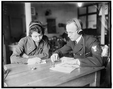 Photo:Evelyn Moran Woman and Man Writing at Table Headphones 1910s