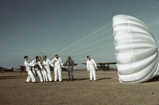 Instructor explaining operation of a parachute to student pilots M- Old Photo