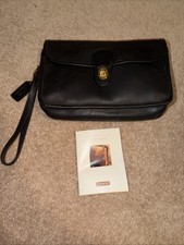 NWOT vintage black leather Coach wristlet features a classic a detachable strap