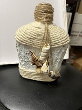 Handmade painted beach style nautical bottle with seashell trim rope and twine