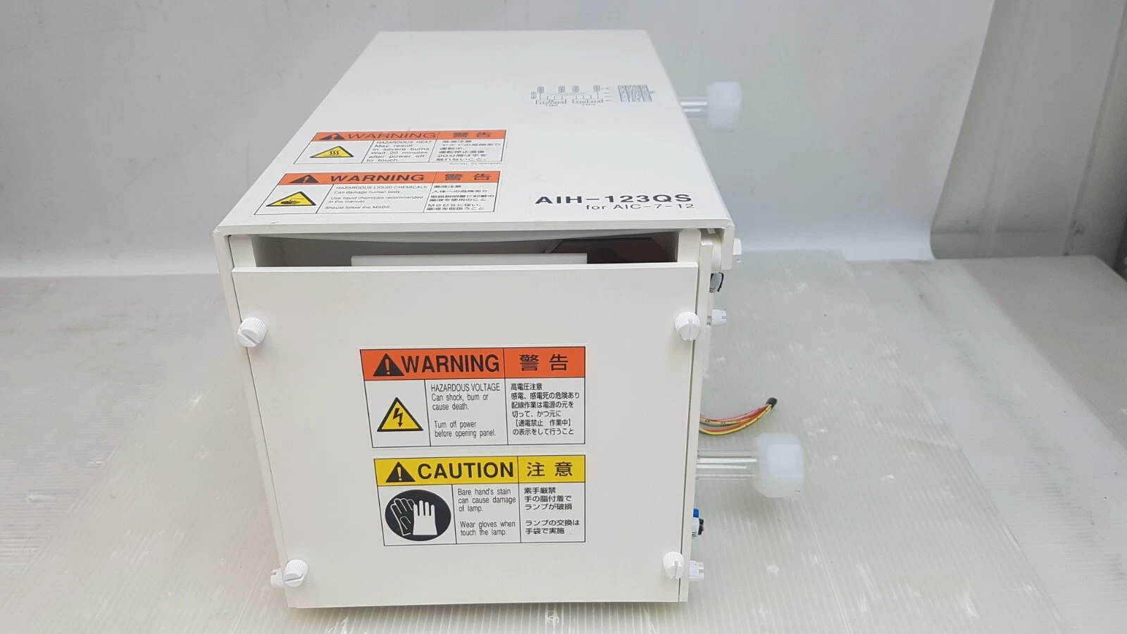 End panel of the AIH-123QS heater with hazardous voltage and lamp handling labels