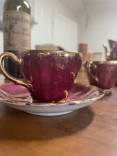 Purple China tea set. 5 cups  saucers, creamer boat, tea pot, and sugar holder