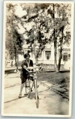 39689098 - Woman with a Bicycle Back Text: On Board M.S. Rio Panca March