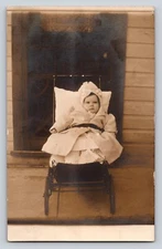 RPPC frown baby stroller buggy Postcard Portrait Real Photo front door